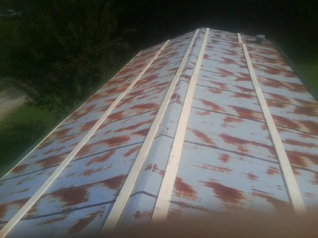 Rusted metal roof panels with new wood purlins before replacement — Storm Damage Roof Repair in Victoria by Roofing Brothers